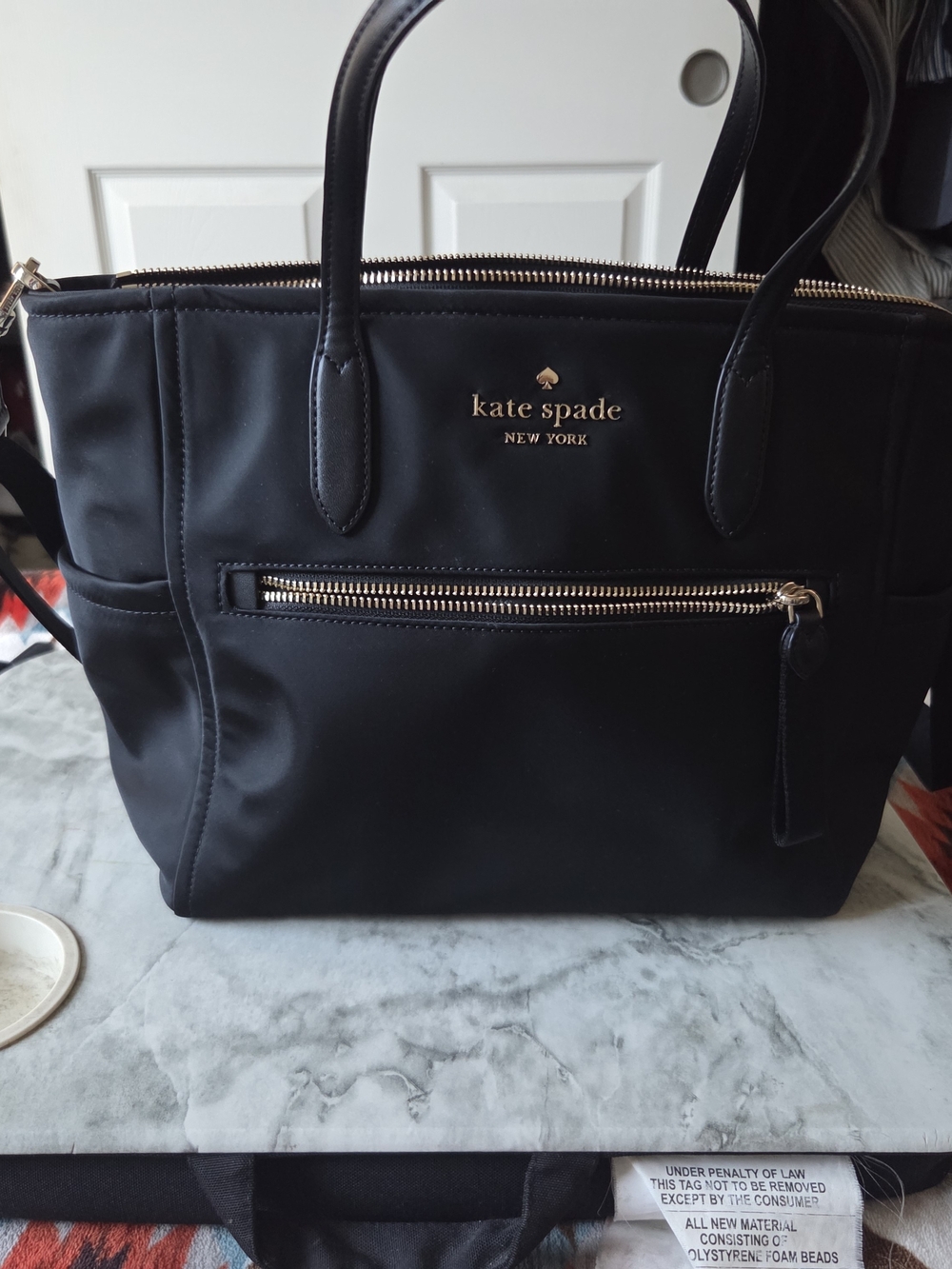 kate spade black tote with front zip and gold logo